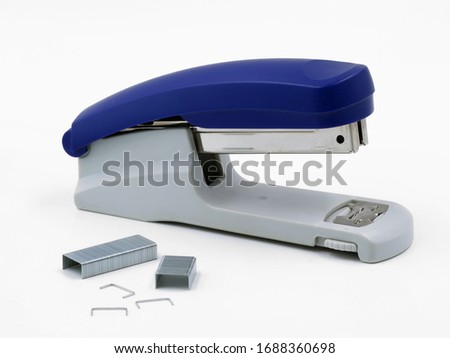 Blue stapler with staples isolated on a white background Royalty-Free Stock Photo #1688360698