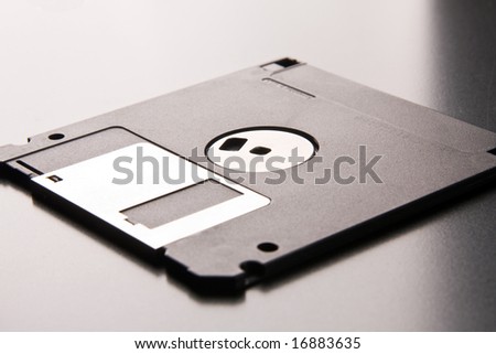 floppy disk lays on a metallic background