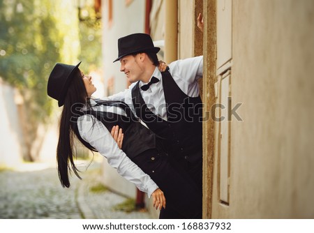 The couple of gangsters are dancing 