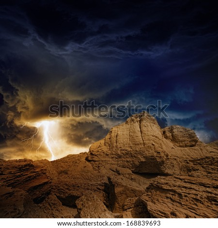 Nature force background - bright lightning in dark stormy sky in mountains