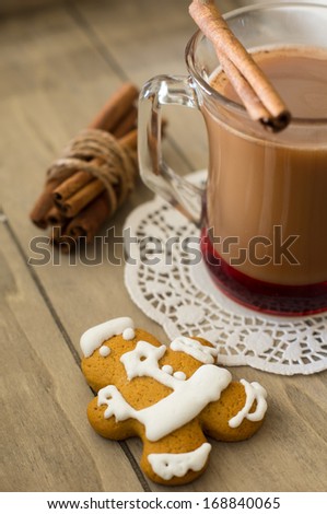 Glass of cacao, cookies and cinnamon on the wooden table