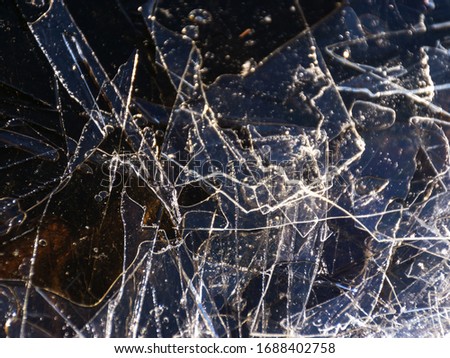 abstract picture background with dry grass, thin ice and water textures, the wind will be destroyed by ice on the coast