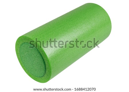 green roller for Pilates, yoga or for fitness, on a white background, warming up and back muscle massage, isolated