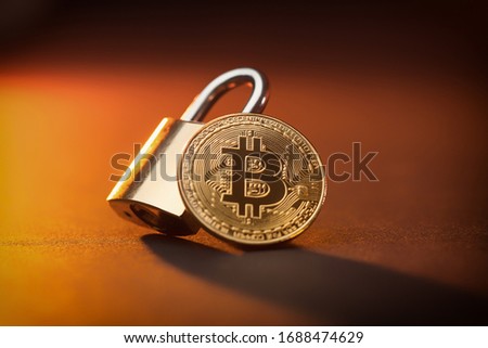 Bitcoin crypto currrency coin and a padlock, crypto shutdown and fall due to Coronavirus global pandemic crisis, stock and economy fall due to uncertainty and anxiety, unstable situation and future Royalty-Free Stock Photo #1688474629