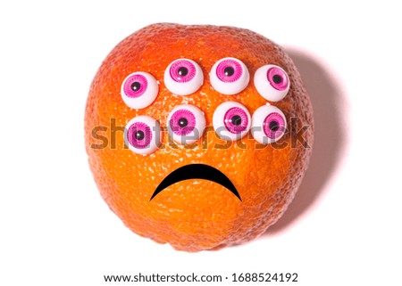 orange fruit with plastic toys eyes