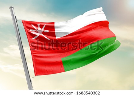 Oman national flag cloth fabric waving on the sky with beautiful sun light - Image