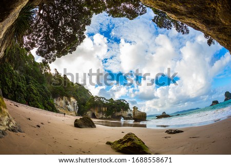 Pacific Coast of New Zealand. The magnificent fantastic Cathedral Cave on the sandy beach. Ocean inflow begins at sunset. The concept of exotic, ecological and photo tourism