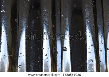 The texture of Corrugated galvanized with some water droplets
