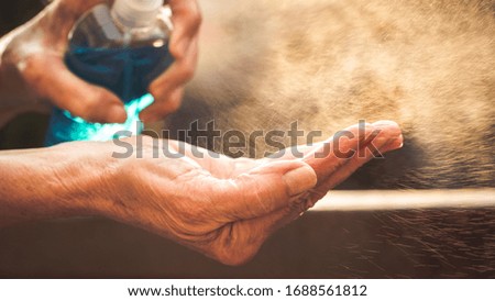 spraying hand sanitizer coronavirus prevention