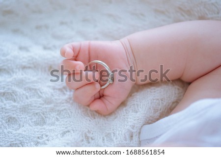 Baby hand. Closeup of baby hand Family concept with the wedding rings in baby finger. Royalty-Free Stock Photo #1688561854