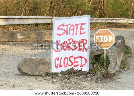 stop traffic sign and information board at closed state border caused by coronavirus