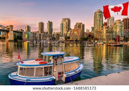 Ferry boat docked along in Granville island near Burrard Street Bridge at twilight in Vancouver,Canada