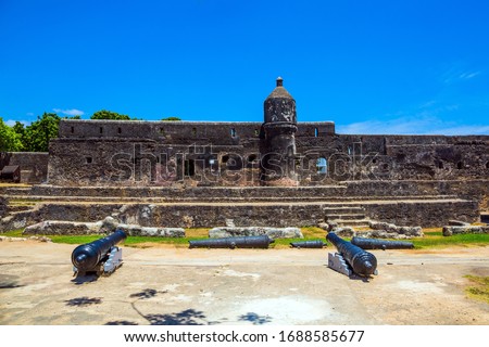 Bastion and loopholes in the thick ancient walls. Fort Jesus -  medieval fortification in Mombasa, Kenya. UNESCO listed Fort as World Heritage Site. The concept of historical, educational tourism
