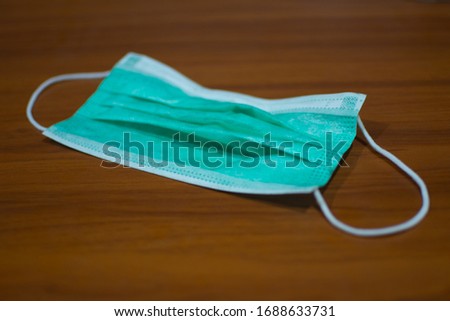 Used 3 layer green surgical mask to prevent corona virus, COVID-19