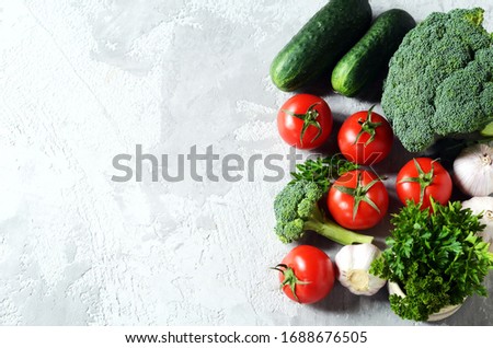 Fresh vegetables: tomatoes, broccoli, cucumbers and garlic. Healthy eating concept. Copy space