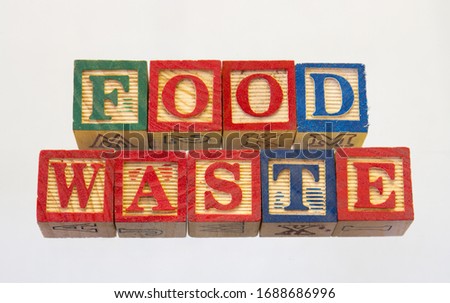 The term food waste isolated on a clear background using colored wooden toy blocks image in horizontal format with copy space