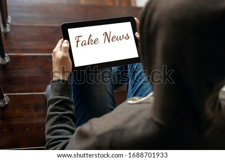 News concept: Tablet Computer with Fake News On Screen on display, braking news with incorrect information about coronavirus, covid-19 Royalty-Free Stock Photo #1688701933