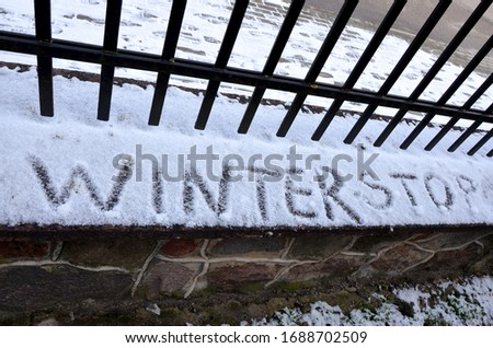 inscription on snow winter stop