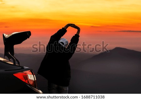 People woman with car. Women standing is travel Mountain view at sunrise with fog trees and beautiful.