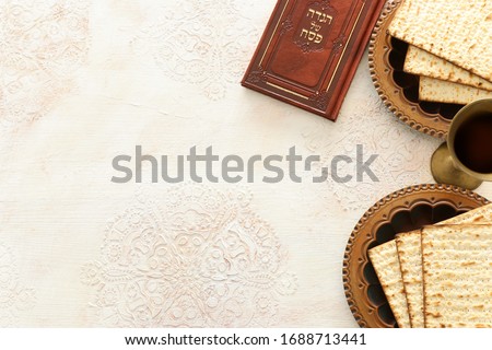 Pesah celebration concept (jewish Passover holiday). Traditional book with text in hebrew: Passover Haggadah (Passover Tale) Royalty-Free Stock Photo #1688713441