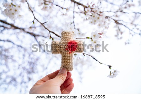 This is a picture of a cherry blossom and a cross.