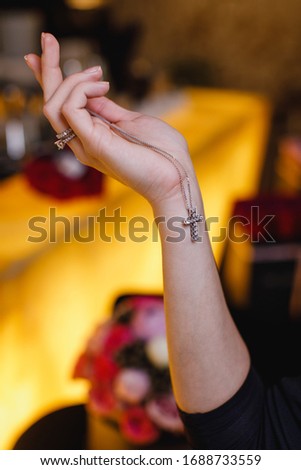 girl holding jewelry cross in her hand