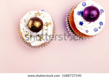 Sweet, colorful cupcakes decorated with sugar paste and cream. Concept of art paty. Flat lay, top veiw.