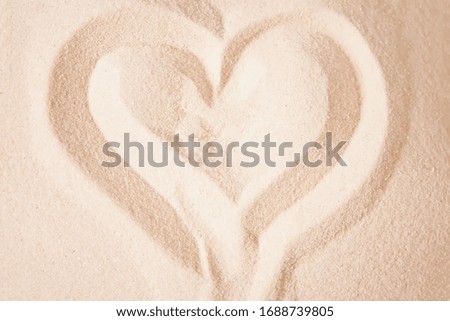 Heart shape draw in the beach sand. Top view