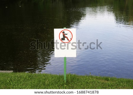 A sign prohibiting fishing in a lake or river.