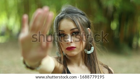 
Serios Millennial girl rejecting with hand saying NO, stop harassment. Woman waving finger