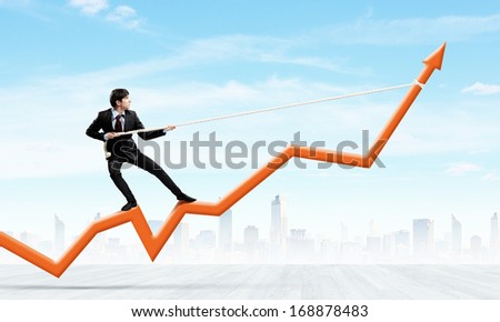 Image of businessman standing on graph and pulling it upwards