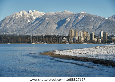    English Bay Winter Cityscape. The Coast Mountains behind English Bay and condominium towers, Vancouver.

                            