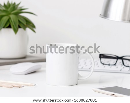 White mug mockup on workdesk with keyboard desk lamp, mouse and pencils Royalty-Free Stock Photo #1688827801