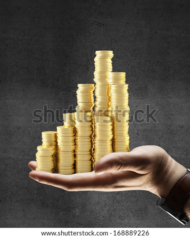 hand holding gold coins city