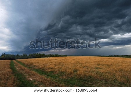 A thunderstorm is approaching, nature froze in anticipation of a storm of swirling, swirling clouds of rain. Royalty-Free Stock Photo #1688935564
