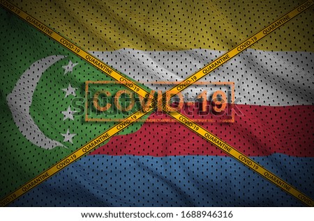 Comoros flag and Covid-19 stamp with orange quarantine border tape cross. Coronavirus or 2019-nCov virus concept