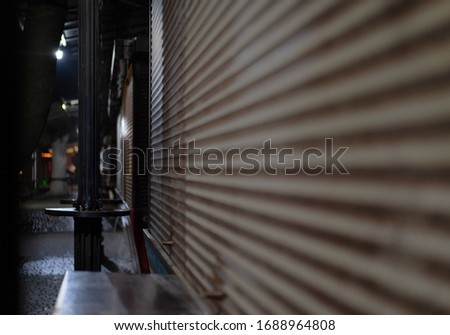 closed metal shutters on a shop window
