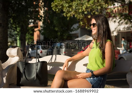 Woman portrait outdoors with green shirt in summer