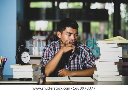 Educational conept: tired student in a library