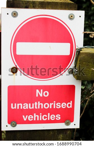 No unauthorised vehicles red and white sign 