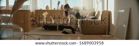 Mother working from home, having a phone call, while her daughter distracts her and drawing attention Royalty-Free Stock Photo #1689003958