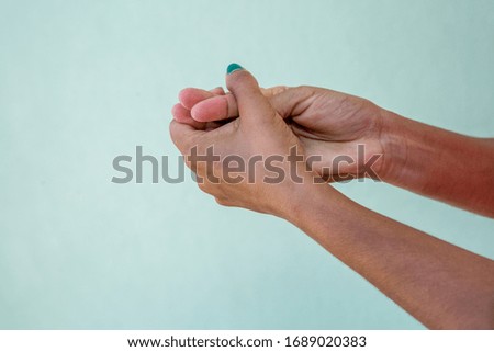 Close up view of woman applying portable antibacterial hand sanitizer on hands