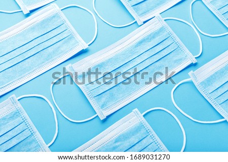 Medical hygienic mask, Face protective masks on blue background.Disposable surgical face mask protective against Coronovirus Covid-19,pollution, virus, flu.Healthcare medical surgical Flat lay pattern Royalty-Free Stock Photo #1689031270