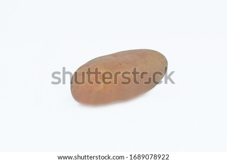 Close up picture of a big brown normal potato isolated in an empty white background
