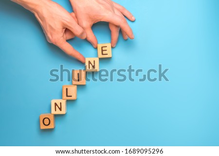 ONLINE - word from wooden blocks with letters. Cubes laid out as upstairs. Online growing business concept. Stack stairs from wood cubes. Growing business online concept. Stack the stairs. Copy space