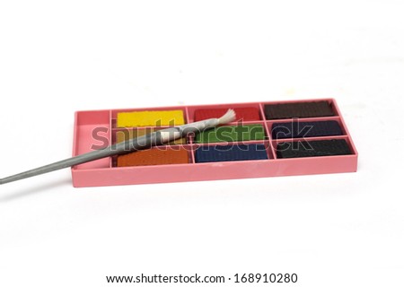 Colorful paint box with a brush. Photo.