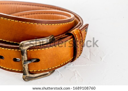 brown man's belt on a light background