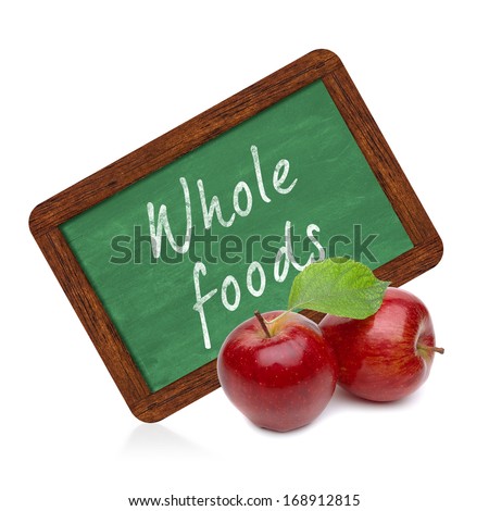 Organic red apples with whole foods chalkboard sign on white background Royalty-Free Stock Photo #168912815
