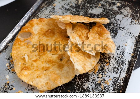 Close up of fried flatbread Yaniqueque (yanikeke, johnnycake) Dominican staple food beach snack Royalty-Free Stock Photo #1689133537