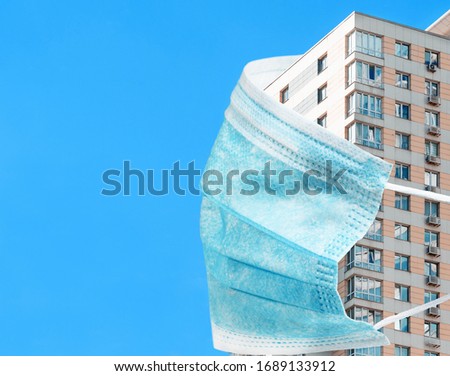 Self isolation and quarantine Covid-19 concept. All stay at home. Self-isolate from a pandemic. Block of flats, apartment building in medical mask.